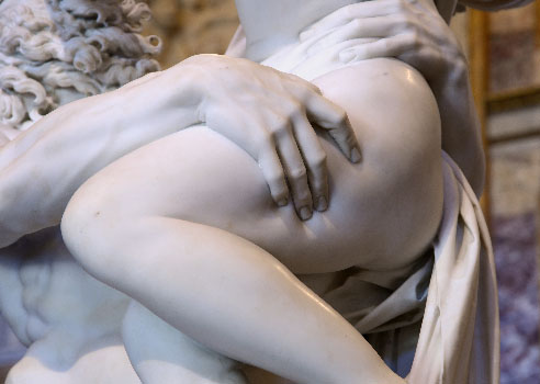 A detail of the above sculpture, showing Persephone's thigh being gripped tightly.